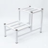 PS02MT0014b Two-tier white galvanised steel plant stand with slatted platforms and protective foot caps. Rust-resistant, powder-coated finish creates a stylish stepped display for indoor or outdoor greenery.
