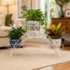 PS03MT0009f Arched black galvanised steel plant stand with three tiered planter holders and decorative scrollwork. Rust-resistant, powder-coated finish creates a striking multi-level display for gardens or patios.