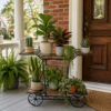 PS06MT0017c Whimsical white galvanised steel plant cart with wheel-shaped accents and five staggered tiered shelves. Rust-resistant, powder-coated finish adds decorative, vintage-inspired charm to garden or patio plant displays.