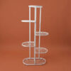 Tall white galvanised steel plant stand with five staggered half-round shelves in a zigzag layout. Rust-resistant, powder-coated finish makes it ideal for displaying multiple plants in a compact footprint.